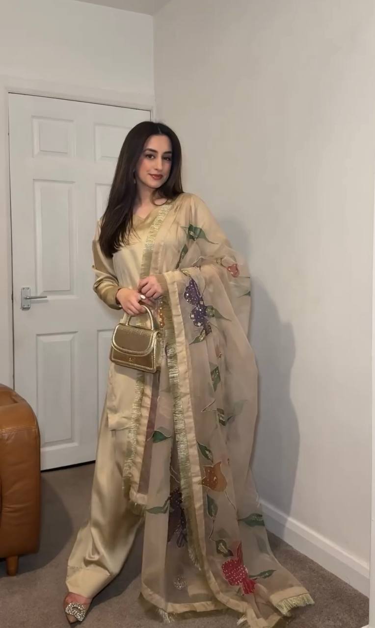 "Grace in Gold & Ivory: Floral Elegance in Traditional Attire"
