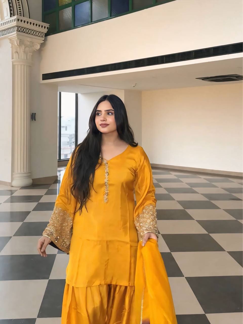 Elegant Brown Traditional Outfit with Orange Dupatta, Embellished Sleeves, and Gold Jewelry Ensemble