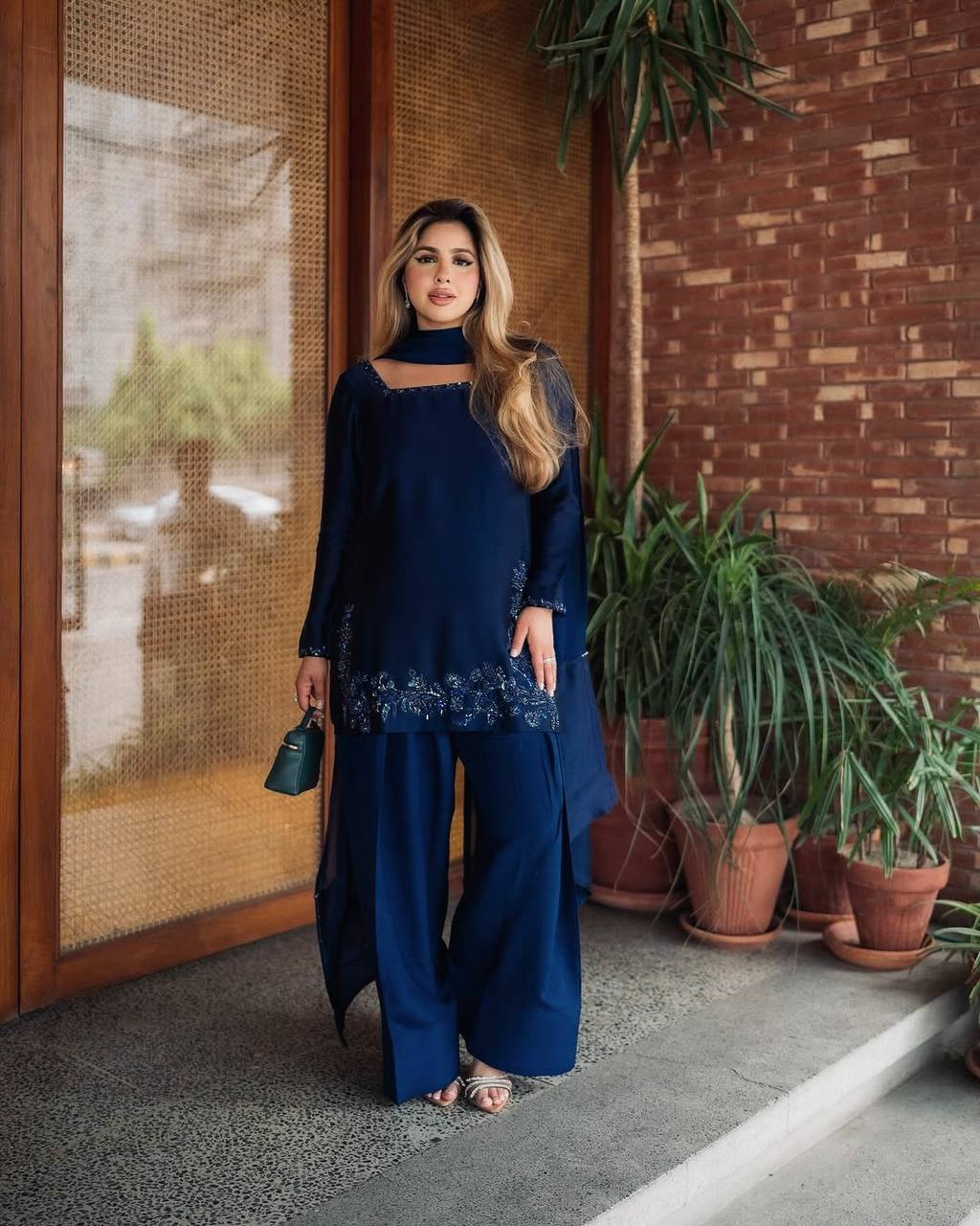 Elegant Harmony: The Blue Suited Muse Embracing Nature's Serenity in a Chic Urban Oasis