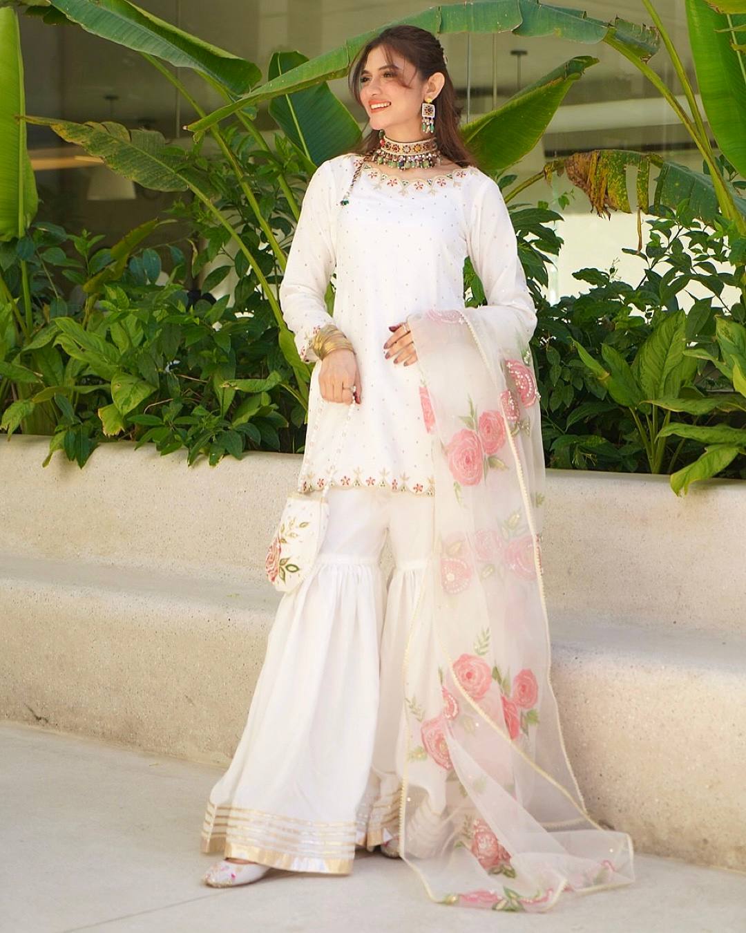 Elegant Blossom: White Embroidered Suit Adorned with Pink Petals